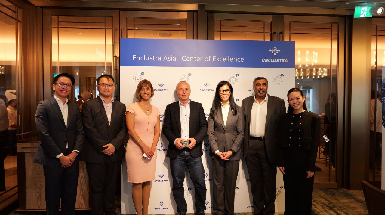 Group photograph at the Enclustra Asia launch with the event display behind the attendees